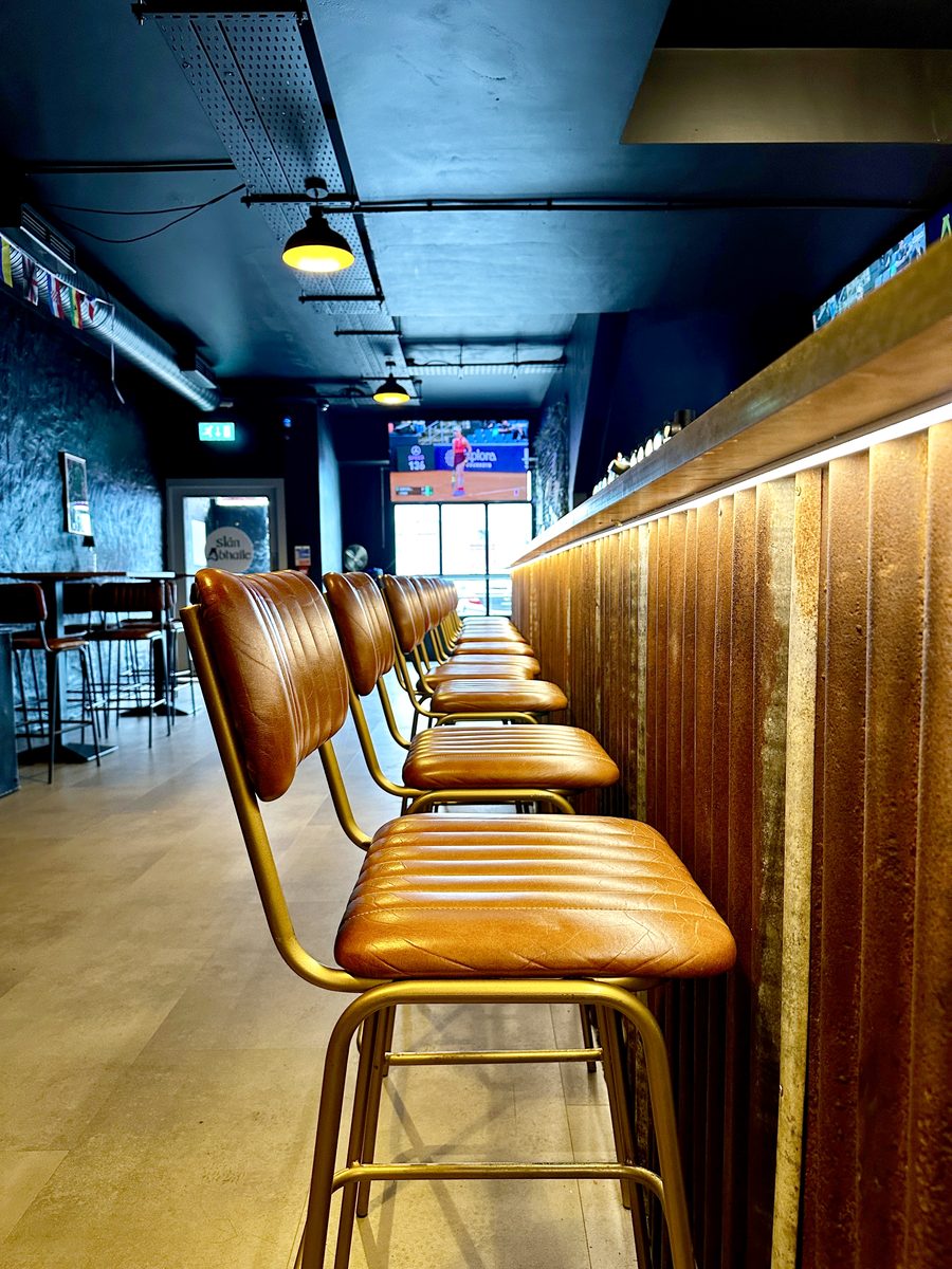 Leather bar stools along the copper bar counter
