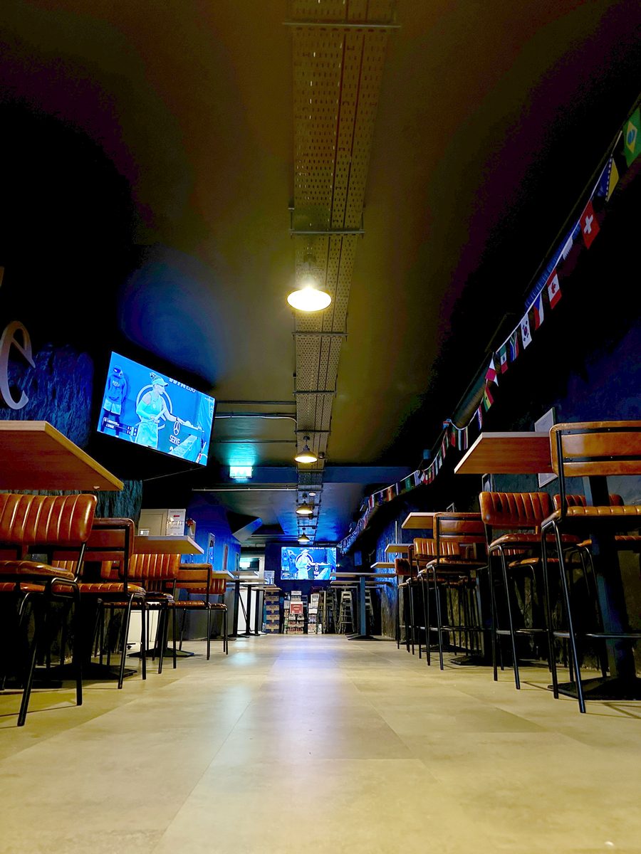 Booth seating and big screens in the sports bar