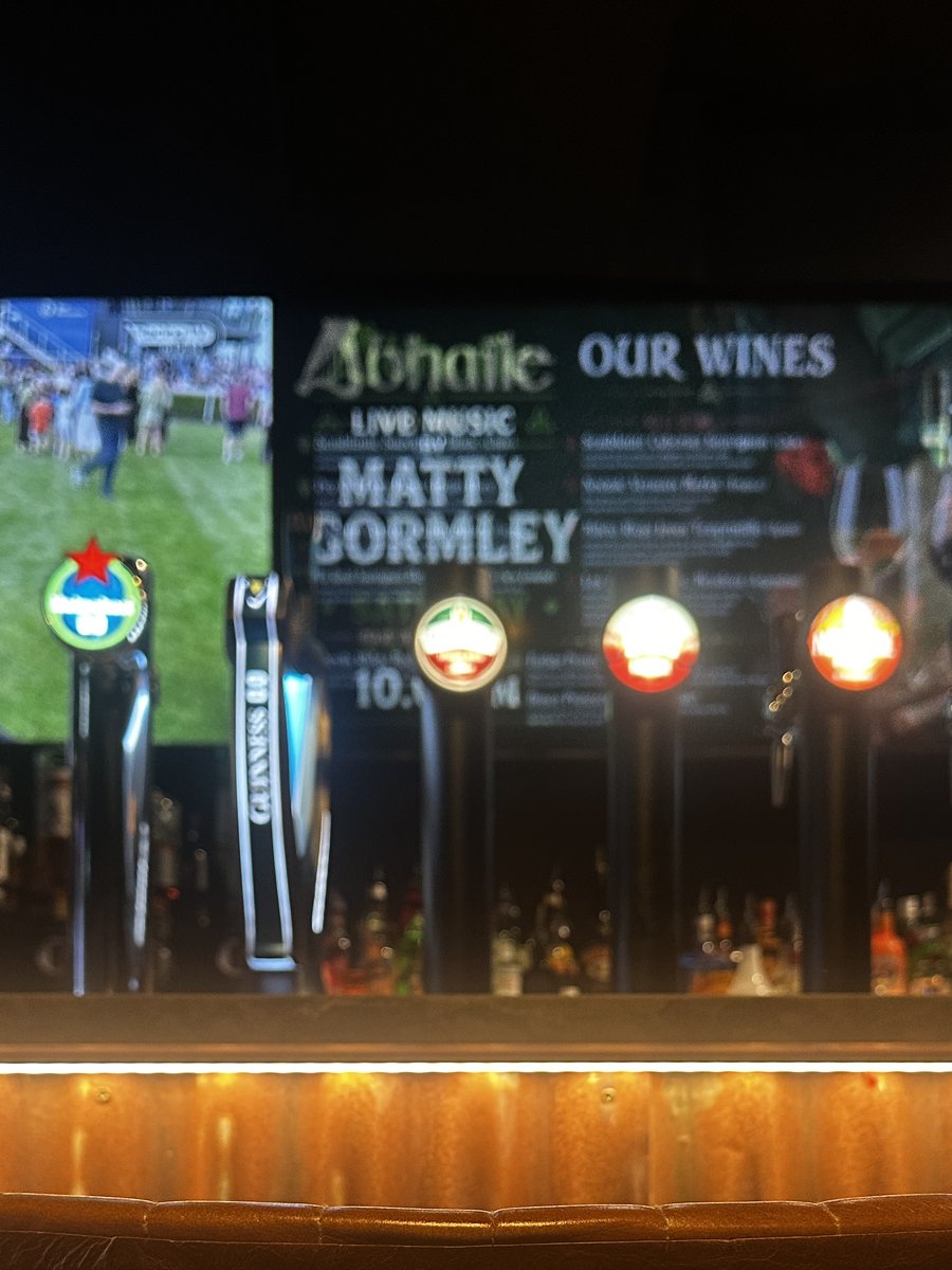 Draught taps below the screens announcing live music and the wine list