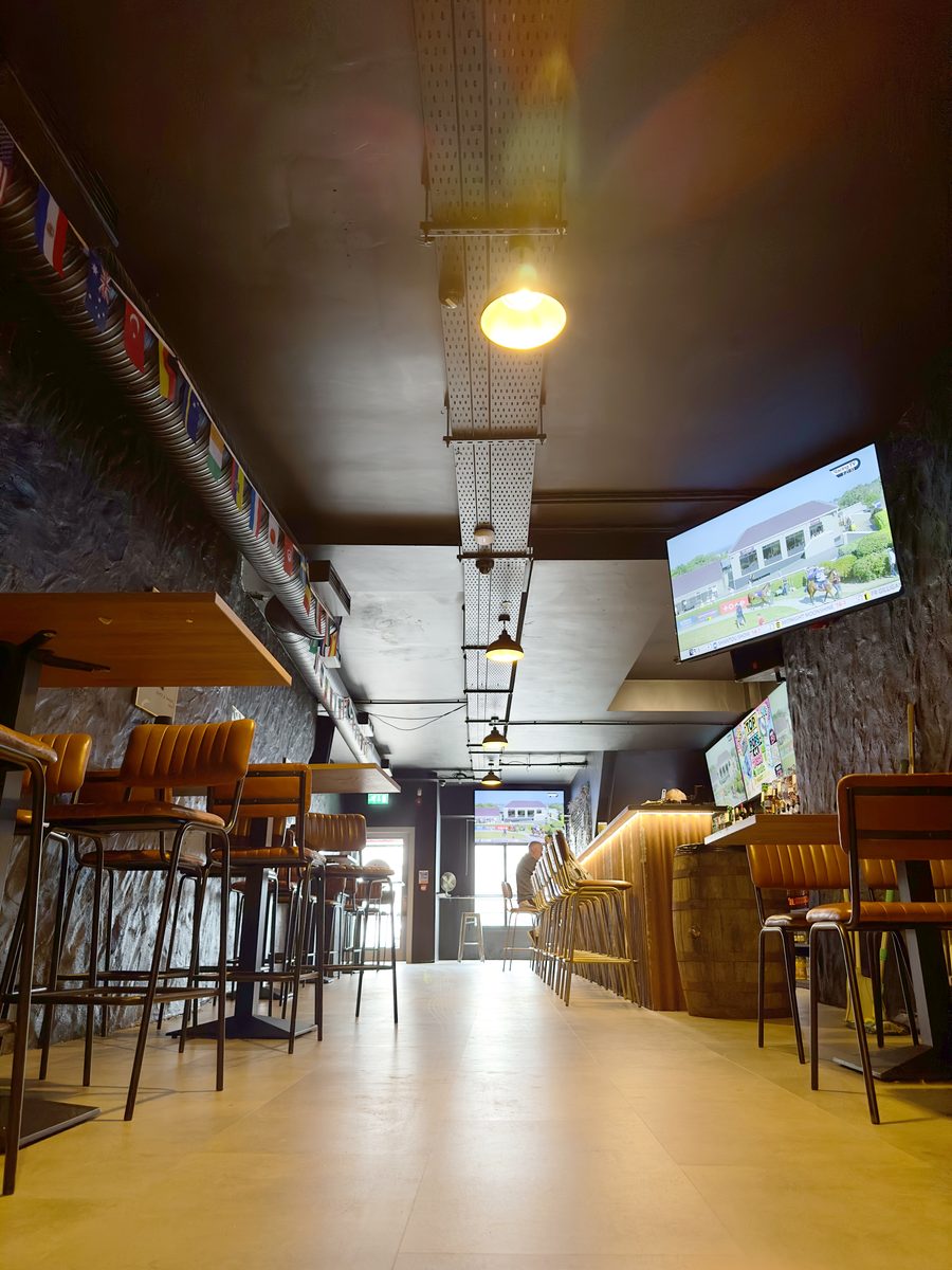 High tables and screens on the sports bar floor