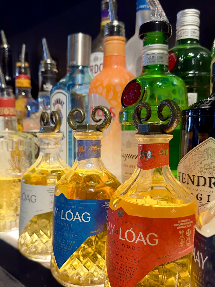 Irish whiskey and gin bottles on the back bar